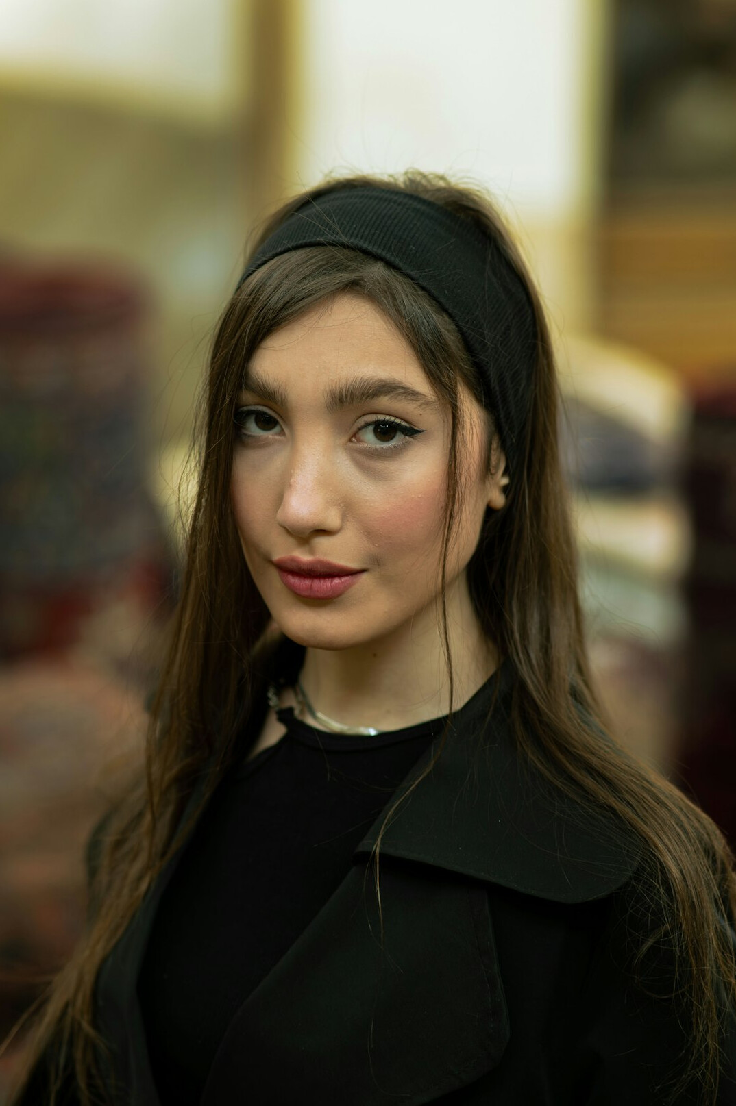 Portrait of a young Latin American woman with dark hair smiling at the camera