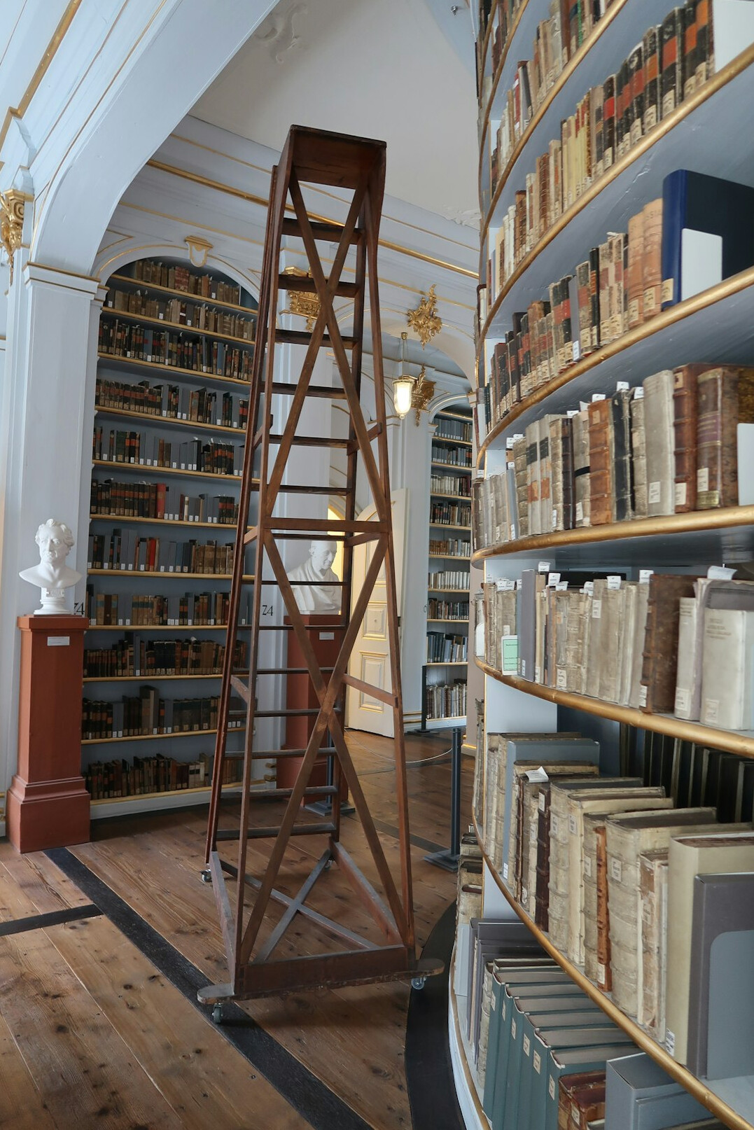 Old library with tall bookshelves full of antique books